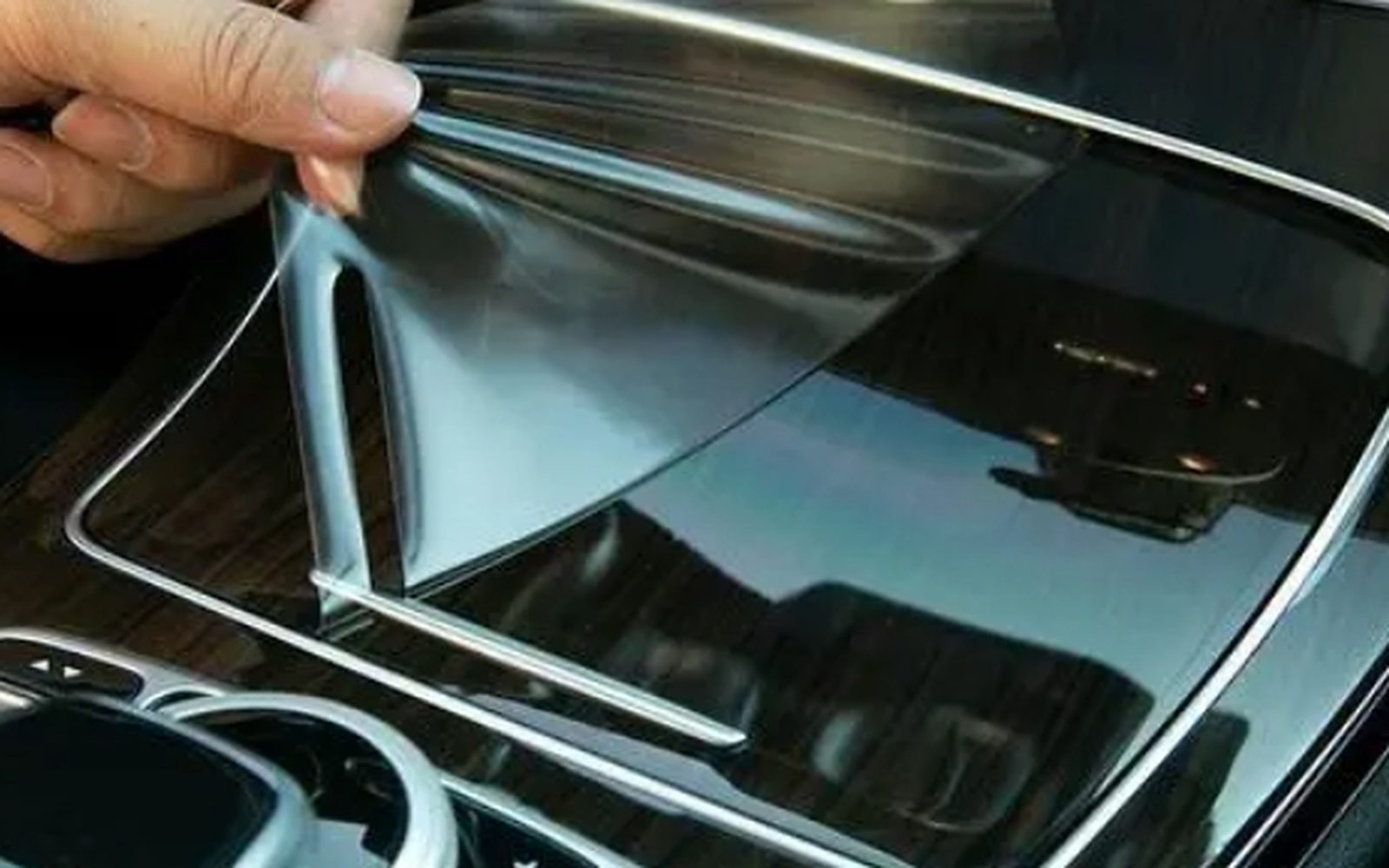 Protective film being applied to a vehicle panel