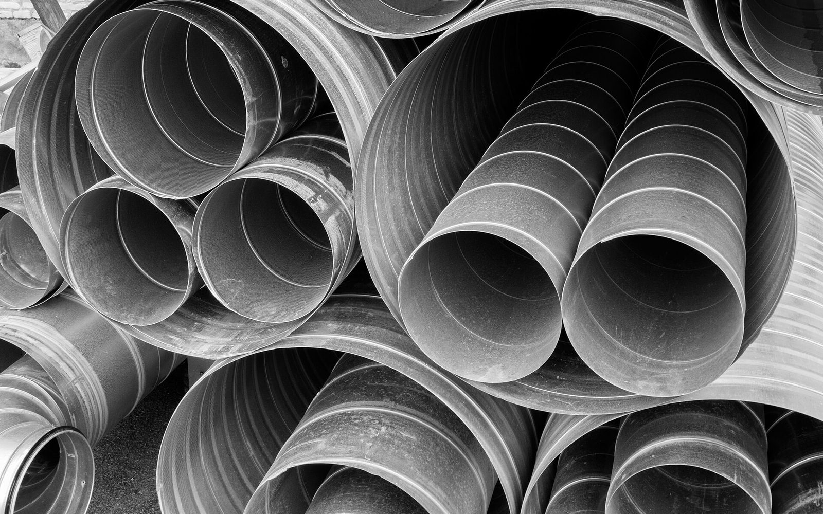 Spiral HVAC ducts stacked for installation (illustrative)