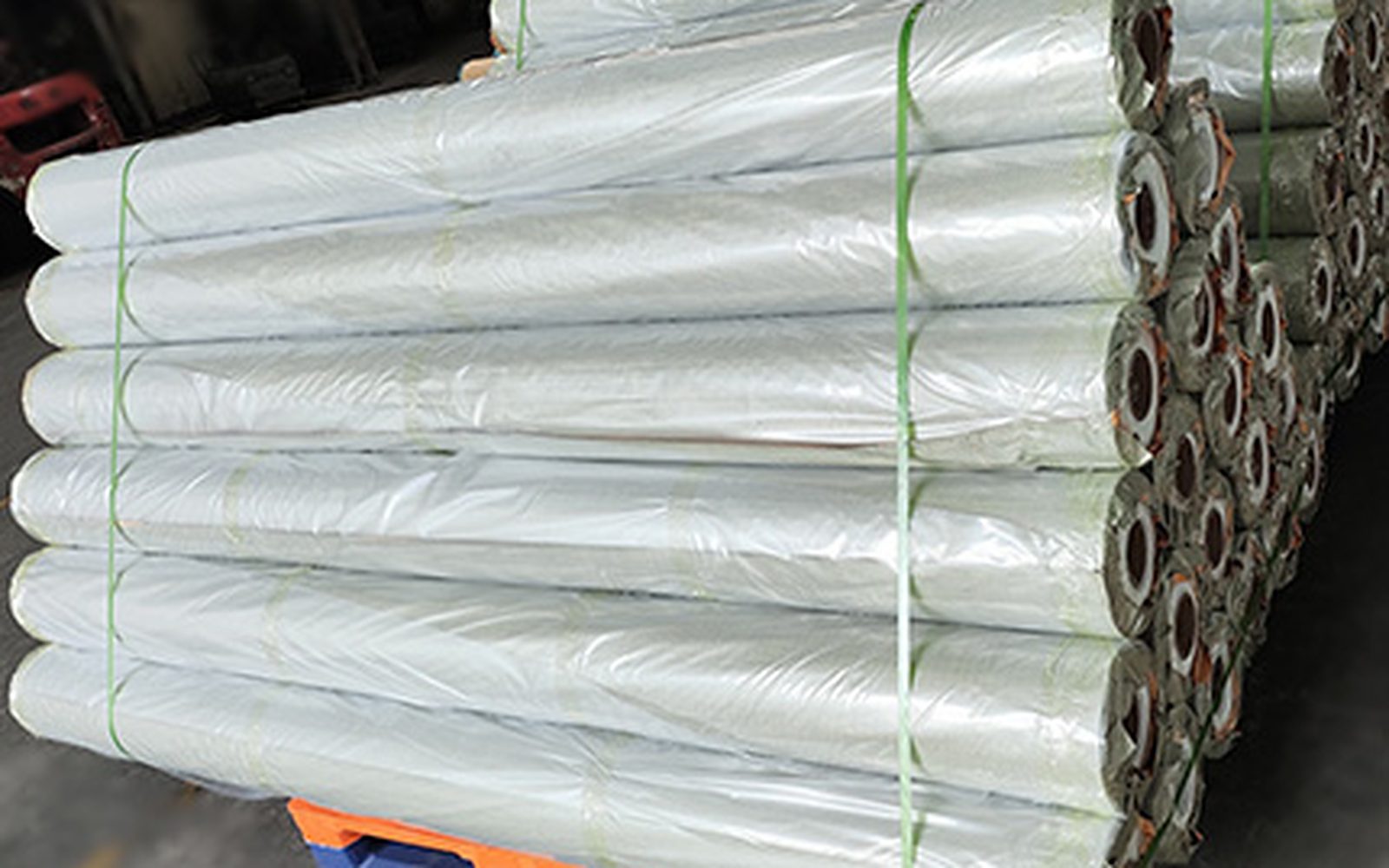 Wrapped film rolls stacked on a pallet